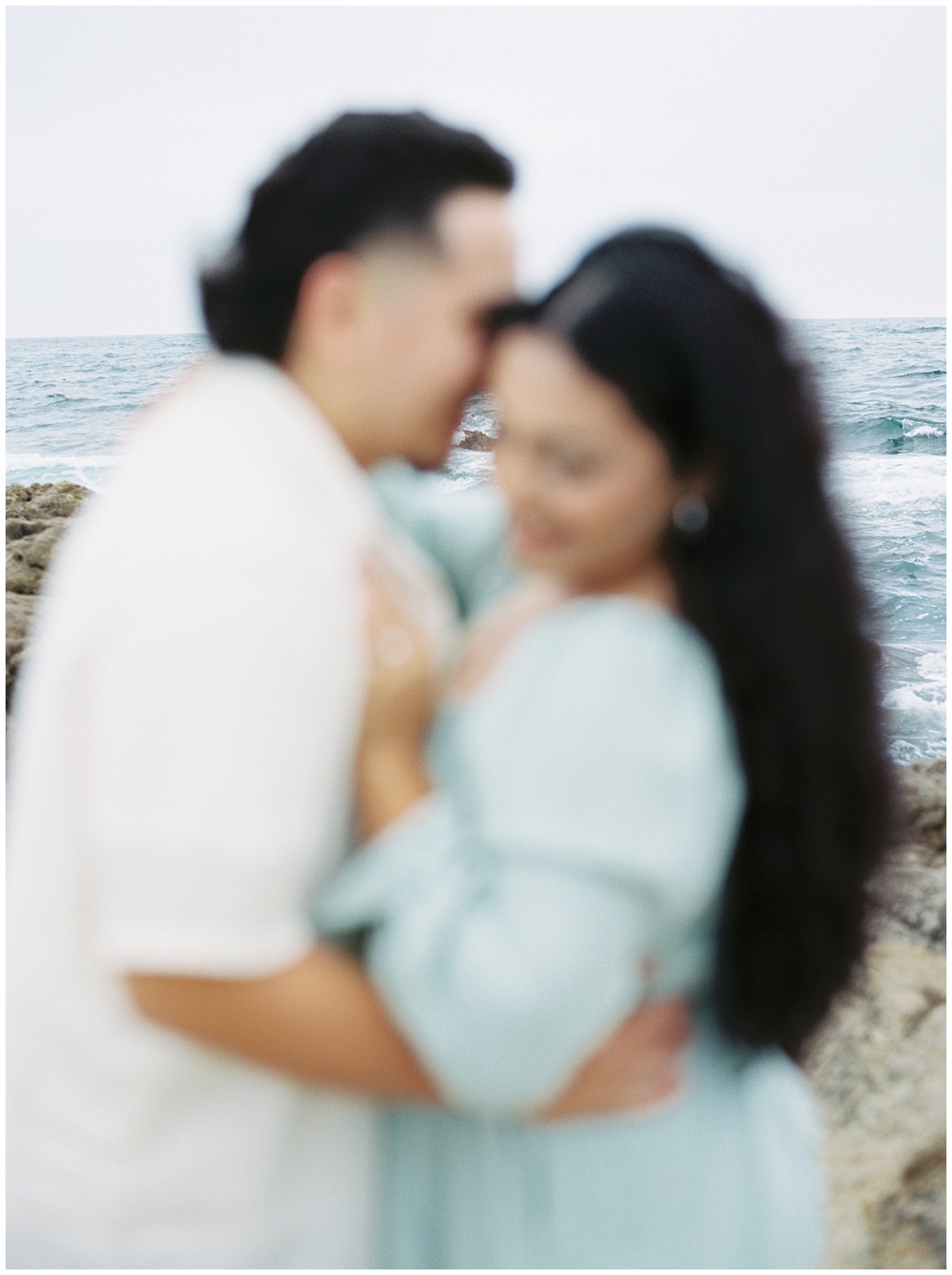 Blurry out of focus documentary style engagement photos at the beach in California.