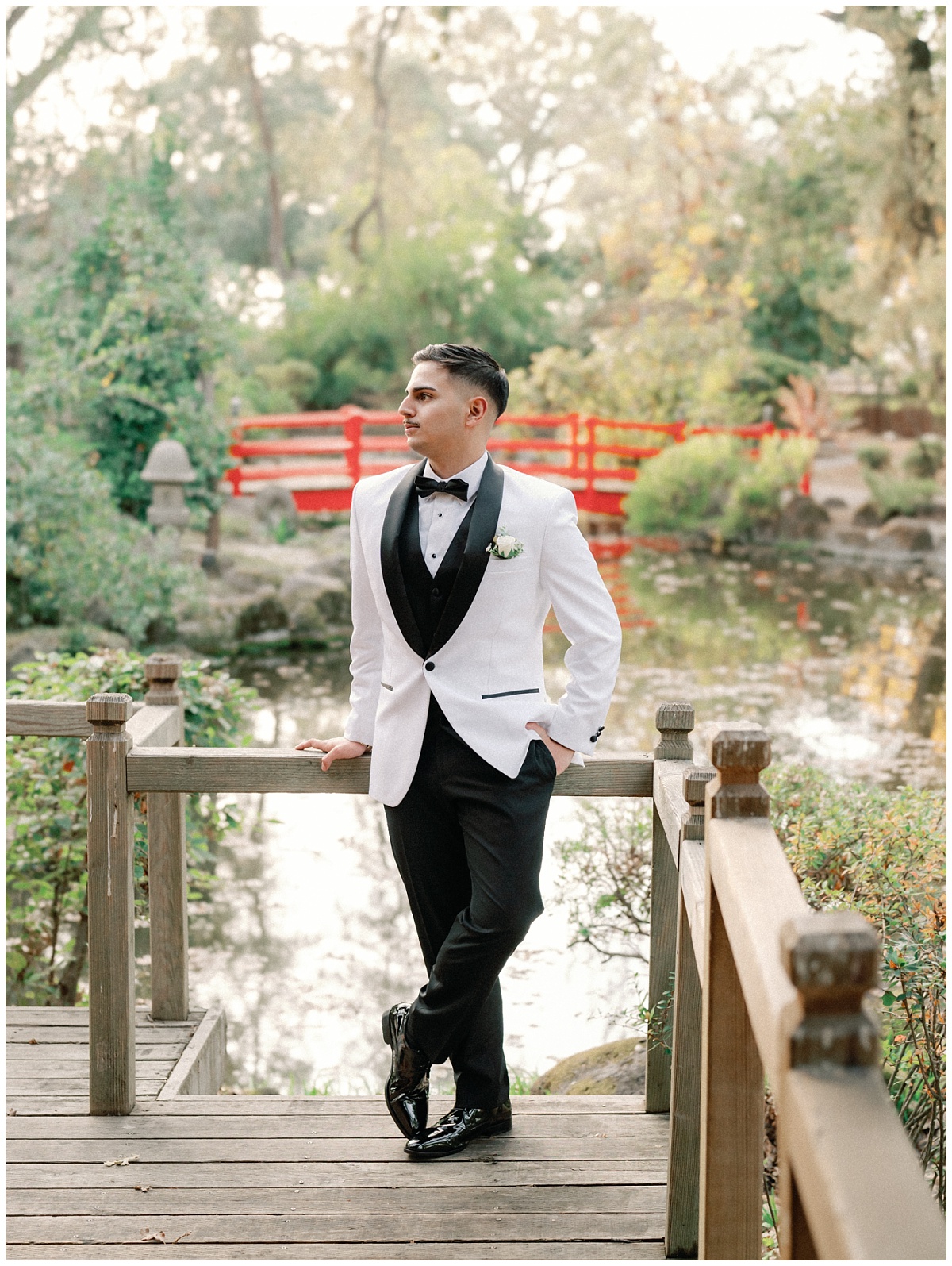 Groom Portraits in the Japanese Garden with the Red Bridge and Koi Pond